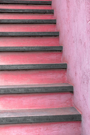 Vertical view of rustic stairs painted pink.の写真素材