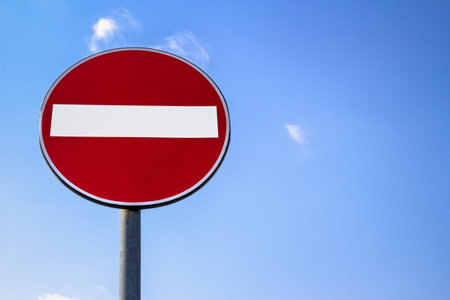 Road sign of access denied with blue sky in the background.