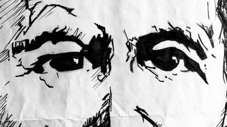 Close up of two eyes drawn on paper in black and white.