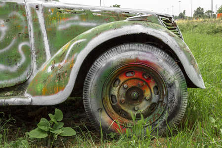 An old abandoned pickup truck, painted with bright colors.の写真素材