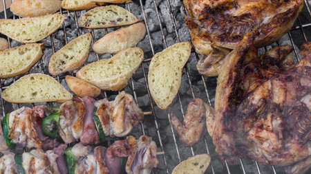 Chicken, skewers and bread grilled on the barbecue.の写真素材