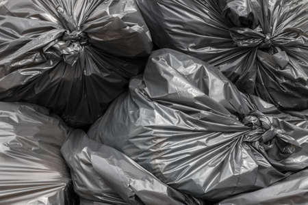 Garbage bags blacks stacked and ready to be picked.の写真素材