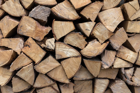 Background of an firewood dry and rough, cut in small pieces.