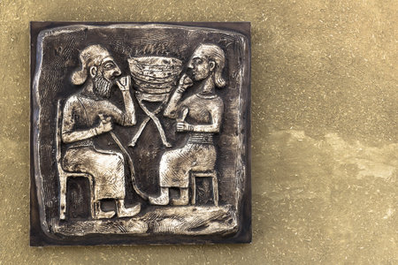 An ancient Mayan relief on bronze tablet with golden tones.