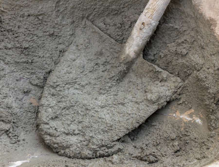 Mortar preparation, on construction site, with shovel and wheelbarrow.の写真素材