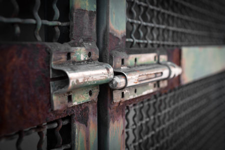 Extreme close-up of a rusty latch, left open.