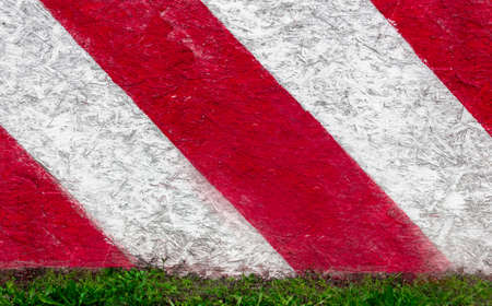 Red and white stripes of color on a plywood panelの写真素材