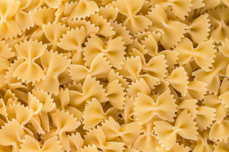 Uncooked "bow-tie pasta" (farfalle). The name of this pasta type is derived from the Italian word farfalla (butterfly).の写真素材
