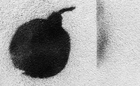 Bomb painted with black paint spray on a white background plasterのeditorial素材