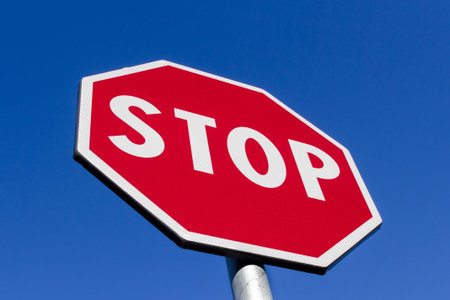 Stop sign against deep blue sky. Close up.