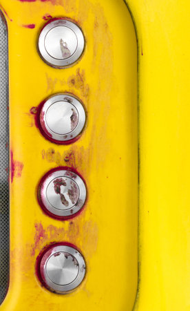 Details of a yellow intercom with disturbing traces of blood on the call keys.の写真素材