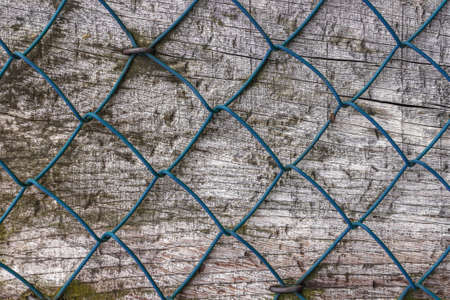 Diamond fence nailed on wood panel.の写真素材