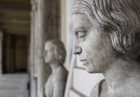 Profile of young sad woman, In the background another statue of a woman and the hall of the museum.のeditorial素材