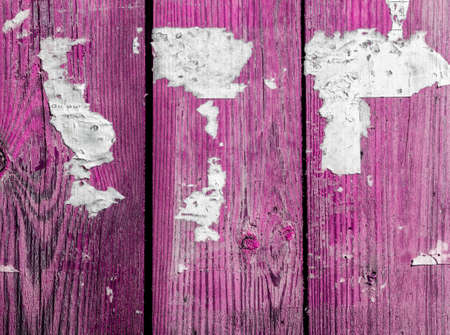 Wooden abstract background with light, scratches and newspaper pieces.の写真素材
