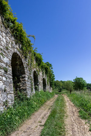 Footpath in countryside with ancient medieval wallの写真素材
