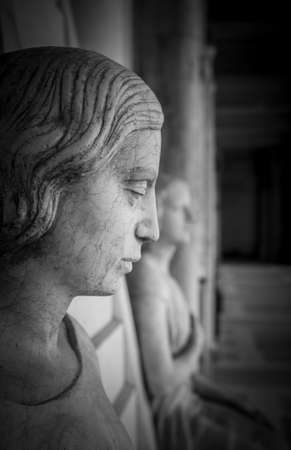 Profile of young sad woman, In the background another statue of a woman and the hall of the museum.の写真素材