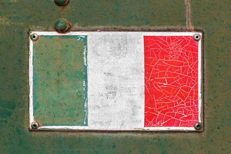 Italian flag on rusty old enamel signの写真素材