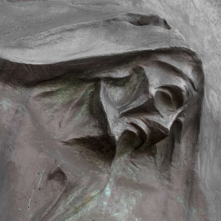 Stone portrait of Grim the Reaper (Death Taker or Angel of the Death). Halloween concept. Halloween sculpture.の写真素材