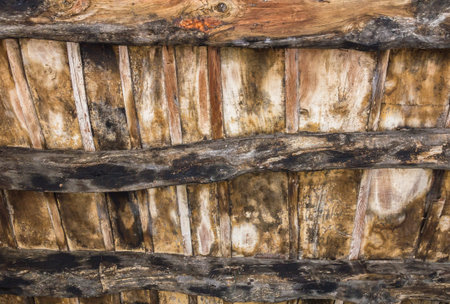 Old wood ceiling with beams on timber backgroundの写真素材