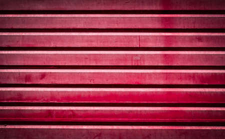 Background of red grunge metallic roller shutter doorの写真素材