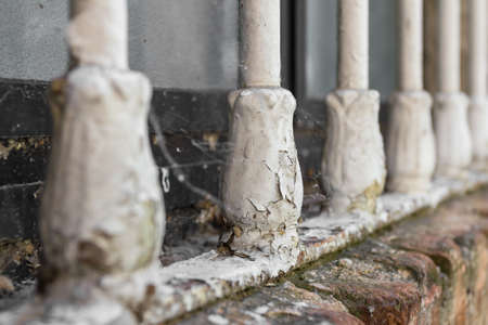 Closeup of old window bars with peeling paint, dirt and cobwebs.の写真素材