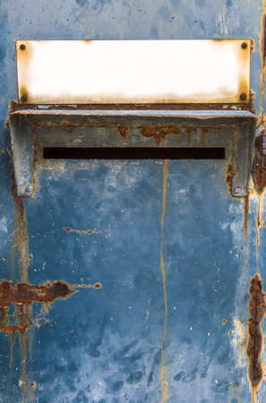 Letter box made of sheet metal with a blank plate for text. Rust and old fingerprints. Concept of time and aging, loneliness and emptiness.の写真素材