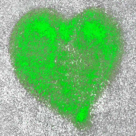 Green heart spray painted on a wall in the backgroundの写真素材