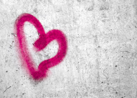 Pink heart hand drawn on concrete wall