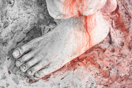 Extreme close-up of the feet of Jesus Christ bloodied. Top view. Shallow depth of field.の写真素材