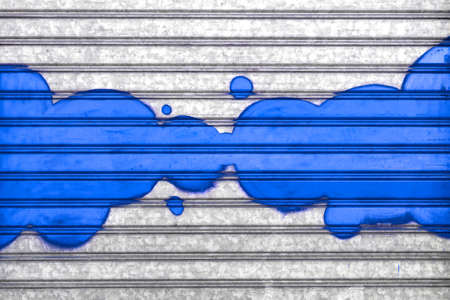 Blue bubbles painted with spray paint on a roller shutter.の写真素材