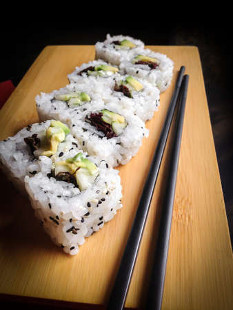 Close up of vegan sushi california roll. Shallow depth of field.の写真素材
