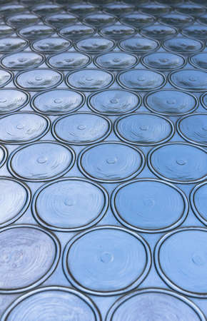 Azure window with circular panes of swirled glass. Shallow depth of field.の写真素材