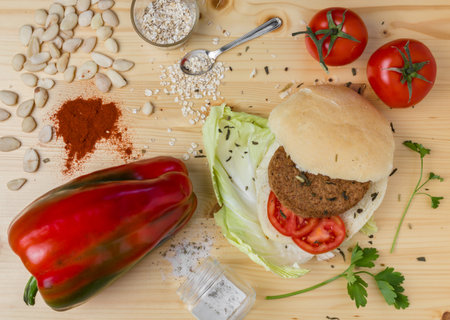 Homemade veg burger with ingredients, on a light wooden background. Top view.の写真素材