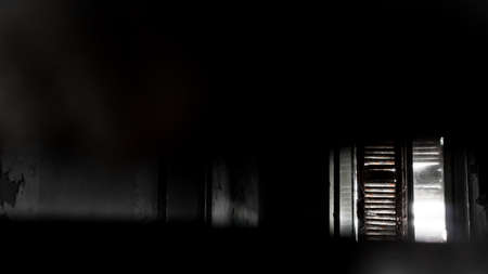 Sunny light enter through the old window creating a disturbing atmosphereの写真素材