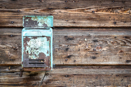 Rusty metal mailbox on the wooden doorwayの写真素材