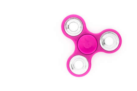 Pink finger spinner (stress anxiety relief toy) isolated on white background.の写真素材