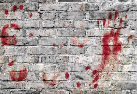 Bloody handprints and blotches of blood on grunge wall. Background for spooky content, halloween and more.の写真素材