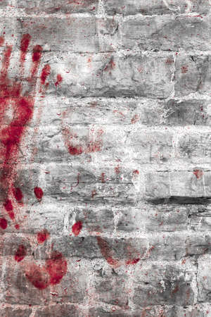 Bloody handprints and blotches of blood on grunge wall. Background for spooky content, halloween and more.の写真素材