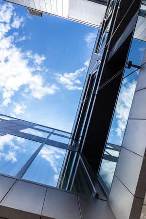 Bottom view of modern office building with amazing sky for copy spaceの写真素材