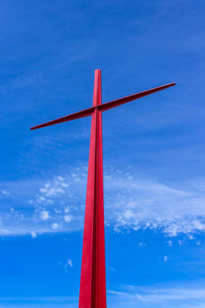 Large red christian cross on sky background. Passion symbology. Easter.の写真素材