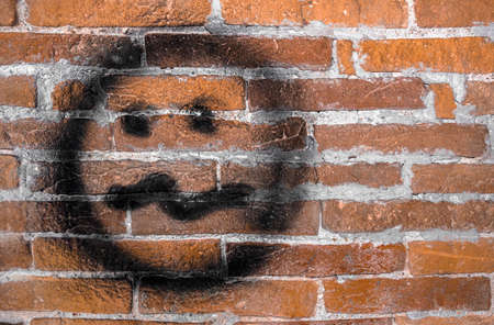 Graffiti wall with needy face. Street art background.の写真素材