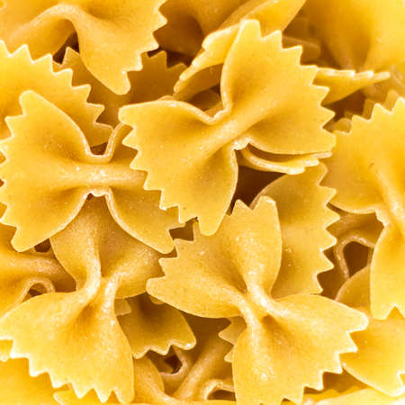 Uncooked farfalle pasta as backgroundの写真素材