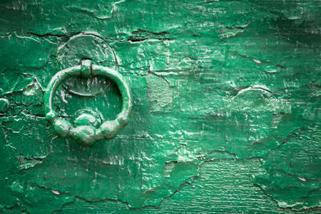 Green wood old knock door. Vintage style. Ideal for backgrounds and texture. Space for text.の写真素材