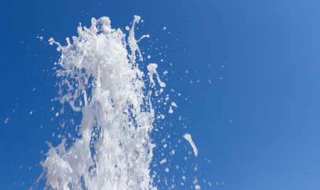 Stream of water from fountain against the blue skyの写真素材
