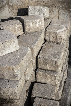 Pile of old pavement bricks, concrete blocks for paving. Pavement bricks are stacking for rearrangement.の写真素材