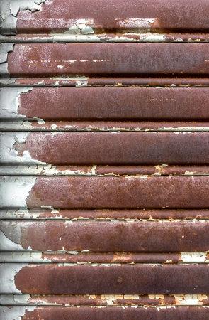 Rusty and lowered rolling shutter with parallel lines. Vintage style.の写真素材