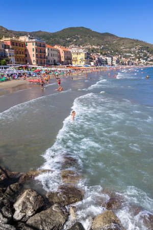 Beach at Alassio (ITALY) with people sunbathing, swimming and relaxing on a warm summer day. Alassio (SV), ITALY - August 21, 2017.のeditorial素材