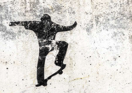 View of a skateboarding themed stencil graffiti piece by an unidentified artist on grungy wall. It can be used as a urban theme, poster, wallpaper, design t-shirts and more.の写真素材