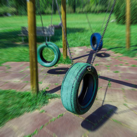 Tire swing in park, background.の写真素材