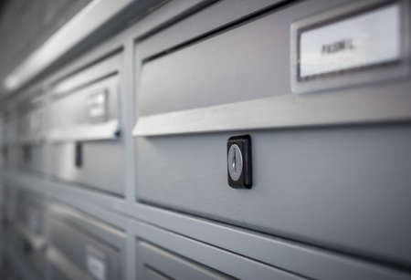 Rows of aluminum mail boxes for concepts such as safety and security, business communication and concepts. Shallow depth of field.のeditorial素材